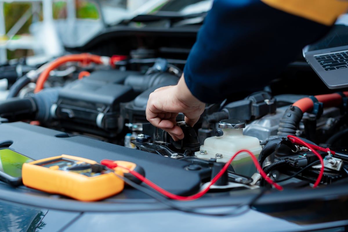Asian male automotive technician who inspects, repairs, and maintains all vehicle systems