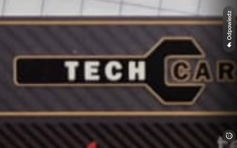 Tech Car logo with stylized wrench design on dark textured background